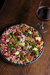 marble beef carpaccio with sauce and herbs