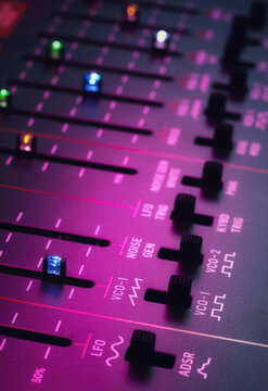 Vintage retro analog synthesizer controls with colourful LED sliders and switches, Synthwave 