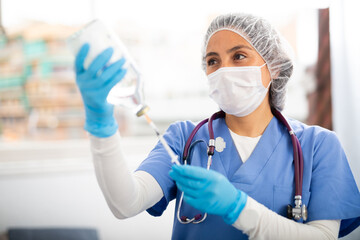 Professional nurse woman making injection in modern hospital