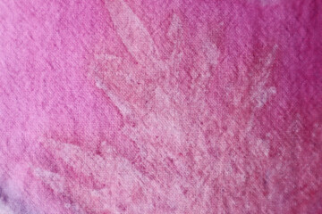 Texture and pattern of natural pink leaf from eco print process. Eco-printing is a technique where plants, leaves and flowers leave their shapes, color and marks on fabric background. 