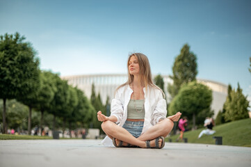 Fototapeta na wymiar Girl practice yoga meditation outdoor in park