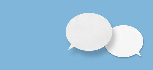 white paper with speech bubbles isolated on blue background communication bubbles