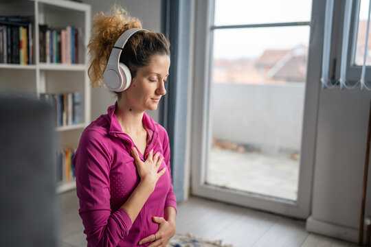 One Woman Doing Guided Meditation Yoga Self Care Practice At Home