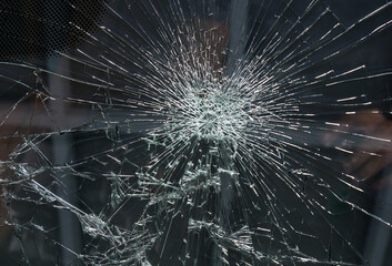 Image of a broken car windshield from a strong impact