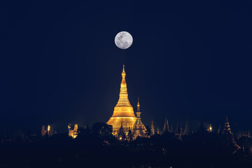 landscape scenery of Shwedagon pagoda on hill at fullmoon night famous sacred place and tourist attraction in Yangon Myanmar