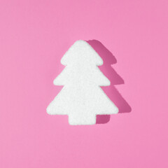 Naklejka na ściany i meble White Christmas tree decoration with pink background. Minimal New Year holiday concept. Flat lay.