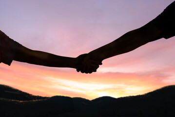 Silhouette handshake hope peace freedom nature morning sun concept of help and hope