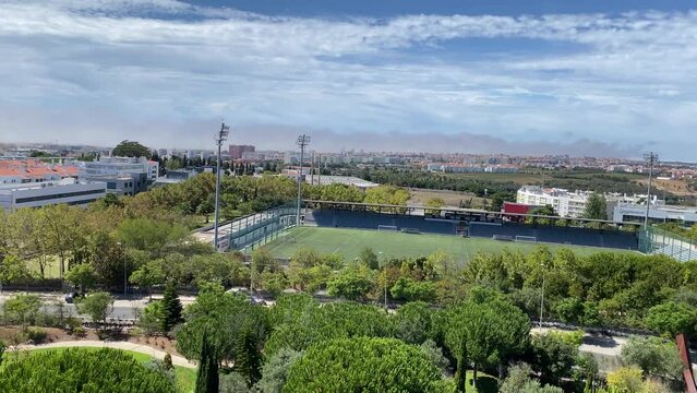 Panning shot of the Municipal Stadium M&aacute;rio Wilson, Poetas Park and the city of Oeiras, Portugal. Aerial video shot by drone