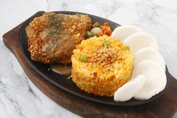 Freshly cooked breaded pork chop served with fried rice