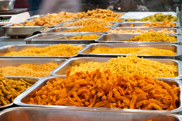 Bhujia, a spicy deep-fried sev filled with a burst of flavors, made using gram flour, moth flour, and different spices, crispy & crunchy traditional namkeen being sold in Jodhpur, Rajasthan, India.
