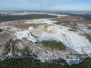 Aerial view to crushed stone quarry in winter with snow.