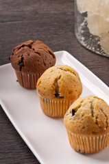 muffins with chocolate on wooden table