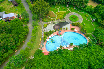 Aerial view of Eco-tourism area in Dong Nai, Vietnam. A weekend getaway for everyone with forests, rivers, waterfalls, swimming pools. Picnics, camping, and relaxation concept.