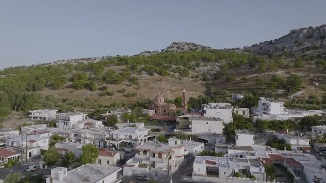 Aerial over Pilonas village in Rhodes, Greece - view of Greek Orthodox church