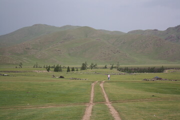 The lonely road in the Orkhon valley, Arkhangai region, Mongolia. The valley is so tranquil all year around. Many nomadic families live around the valleys. 