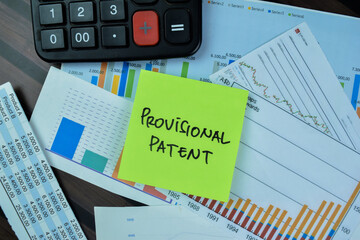 Concept of Provisional Patent write on sticky notes isolated on Wooden Table.