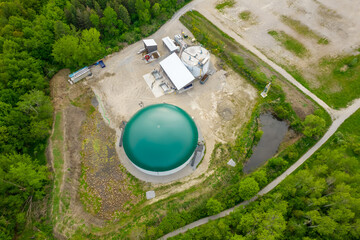 Biogas plant and farm in park or green space in Toronto, Canada. Renewable energy from biomass such as organic food waste and zoo manure. Storage tank for biogas and power produce. - obrazy, fototapety, plakaty