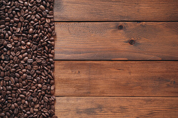 Coffee beans on old wood background with copy space