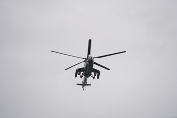 Fototapeta na wymiar Almaty, Kazakhstan - 04.14.2022 : A military helicopter flies over the training ground during an exercise.