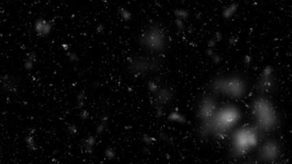 Falling snow isolated on black background. Falling snow at night. Bokeh lights on black background, flying snowflakes in the air. Winter weather. Overlay texture.