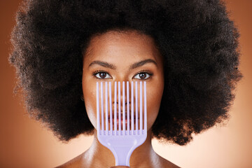 Beauty, hair care and black woman with an afro comb in a studio isolated by a brown background. Health, wellness and portrait of a African model with big beautiful natural curly hair and a brush. - obrazy, fototapety, plakaty