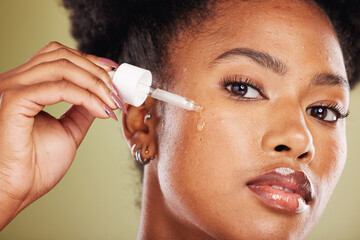 Black woman, dropper and face for skincare cosmetics, oil or hydration against a studio background. Portrait of African American female applying facial serum drops for healthy moisturizing treatment