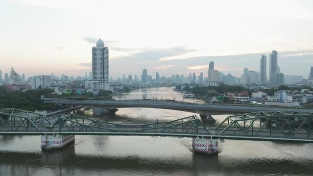 Aerial view of Phra Buddha Yodfa Bridge, Memorial Bridge and Phra Pok Klao Bridge over the Chaophraya River at sunrise scene, Bangkok City, Thailand.