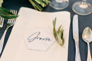 A white napkin at a wedding reception with the word 