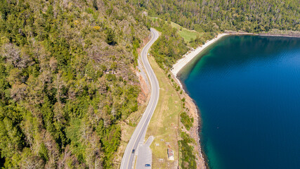 Aerial view of a road bordering a lake in southern Chile