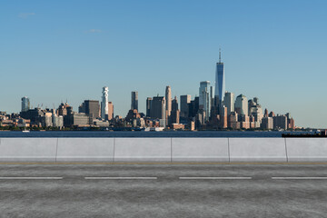 Obraz premium Empty urban asphalt road exterior with city buildings background. New modern highway concrete construction. Concept of way to success. Transportation logistic industry fast delivery. New York. USA.