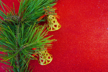 Red Christmas background with Christmas tree branch and Christmas balls and toys