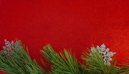 Red Christmas background with Christmas tree branch and Christmas balls and toys