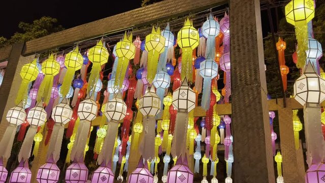 Varieties Lanna paper lanterns hanging for decoration in Chiang Mai gate during Loi Kratong or Yi Peng festival. Hanging Colorful paper lamp northern Thai Lanna traditional art style in temple.