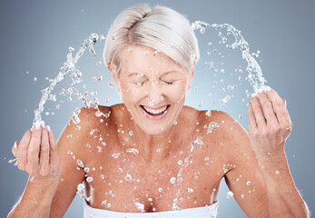 Mature woman, water splash or washing face in skincare grooming routine, morning hygiene...