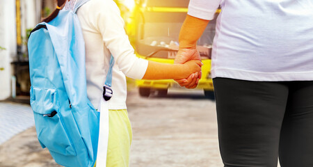 Grandma walked out and sent her granddaughter on a yellow school bus to safely transport students to school : Yellow school bus to transport students to school safely.