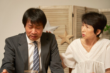 家で落ち込む中年のビジネスマン