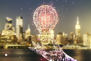 Fototapeta na wymiar Abstract virtual light bulb hologram on blurry office buildings background, idea concept. Multiexposure