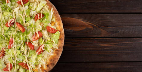 Delicious pizza Caesar with white chicken, sauce, parmesan, cherry tomatoes and fresh lettuce at...