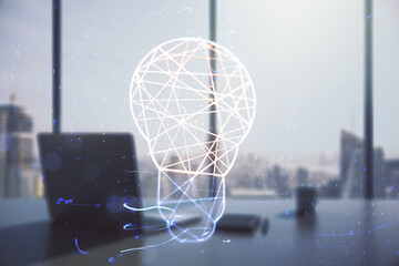Creative light bulb hologram and modern desk with computer on background, idea concept. Multiexposure