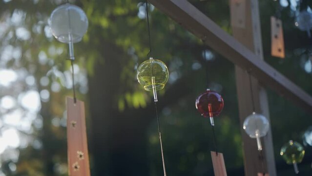 A wind chime shining in the setting sun