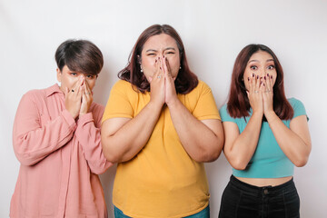 A portrait of three friends shocked, expressing disbelief feeling, isolated by a white background