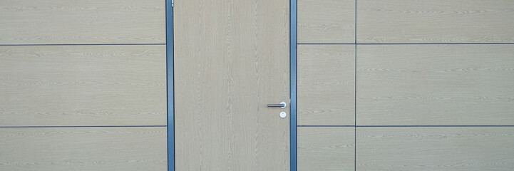 Wooden door to match wall in building background