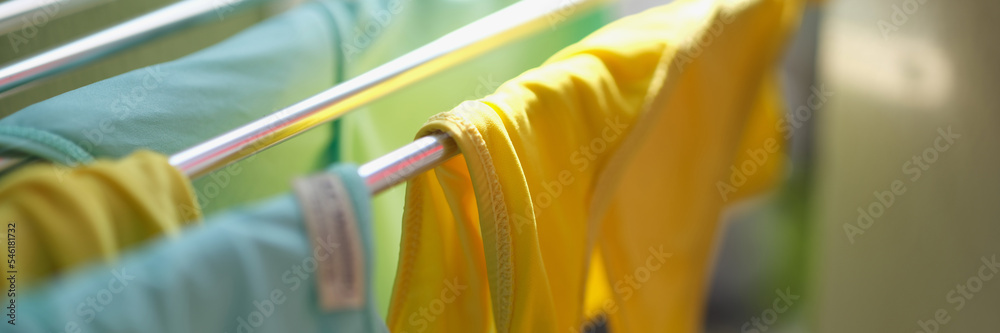 Wall mural clean washed clothes are dried in metal dryer closeup