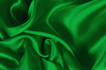 Green fabric texture background, detail of silk or linen pattern.