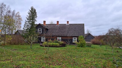 Wooden old houses of the Pastarins Museum on a cloudy autumn day 2022