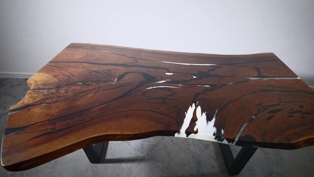 Luxury kitchen table made of wood slab and epoxy resin. Premium and exclusive furniture