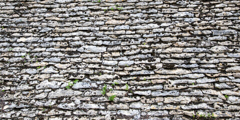 ancient grey tile stone wall background of house roof gray stones wallpaper