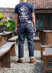 Men wearing leather boots and black denim jeans standing on the rock