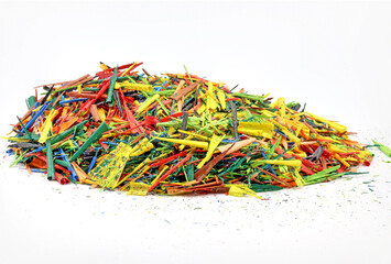 A mountain of shavings taken from pencils and colored paints, with a pencil sharpener