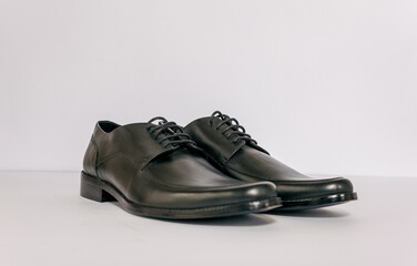 Black men shoes on the white background. Eye level look and able to added text on the side.